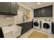 Well-equipped laundry room features sleek cabinetry, laundry sink, and modern washer and dryer at 1993 Mount Vernon Pl, Dunwoody, GA 30338