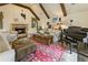 Cozy living room featuring beamed ceiling, stone fireplace, and lots of natural light at 1993 Mount Vernon Pl, Dunwoody, GA 30338
