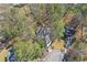 Aerial view of property showcasing the home's placement within a wooded neighborhood at 325 Upper Creek Ct, Roswell, GA 30076