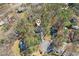 Aerial view of property showcasing the home's placement within a wooded neighborhood at 325 Upper Creek Ct, Roswell, GA 30076