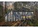 Exterior rear view of the home with a deck, patio, and seating area at 325 Upper Creek Ct, Roswell, GA 30076
