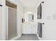 Modern bathroom with walk-in shower, vanity, and gray floor tiles at 325 Upper Creek Ct, Roswell, GA 30076