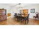 Formal dining room with dark wood table and chairs, and a view into the kitchen at 325 Upper Creek Ct, Roswell, GA 30076