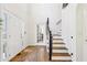 Bright entryway featuring hardwood floors, stairs to the second level, and a transom window at 325 Upper Creek Ct, Roswell, GA 30076