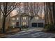 Beautiful two-story home featuring a two-car garage and manicured front yard with lush trees at 325 Upper Creek Ct, Roswell, GA 30076