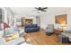 Bright living room with hardwood floors, wainscoting, ceiling fan, and comfortable seating arrangement at 325 Upper Creek Ct, Roswell, GA 30076