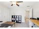 Bright office featuring neutral walls, carpet, a ceiling fan, and a work area at 325 Upper Creek Ct, Roswell, GA 30076