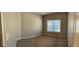 Neutral-toned bedroom featuring wall-to-wall carpet and large window at 359 Cannongate Rd, Sharpsburg, GA 30277