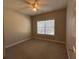 Bedroom with a ceiling fan, neutral walls, and a large window with blinds at 359 Cannongate Rd, Sharpsburg, GA 30277
