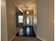 Hallway featuring an elegant front door, tile flooring, and a decorative pendant light at 359 Cannongate Rd, Sharpsburg, GA 30277