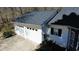 Large two-car garage with white doors and a paved driveway at 359 Cannongate Rd, Sharpsburg, GA 30277