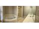 Bathroom boasting double sink vanity, glass shower and large jetted tub at 359 Cannongate Rd, Sharpsburg, GA 30277