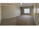 Spacious main bedroom with tray ceiling, plush carpeting, and a bright window at 359 Cannongate Rd, Sharpsburg, GA 30277
