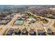 Aerial view of the community with mature trees, showcasing the pool and tennis courts at 4645 Dandelion Way, Cumming, GA 30040