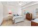 Bright bedroom features a tray ceiling, neutral walls, carpet floors, and traditional-style furniture at 4645 Dandelion Way, Cumming, GA 30040