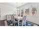 Well-lit dining room with a chandelier, neutral-toned furniture, and large windows, perfect for meals at 4645 Dandelion Way, Cumming, GA 30040