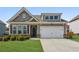 Charming home featuring a two-car garage, well-manicured lawn, and neutral exterior paint at 4645 Dandelion Way, Cumming, GA 30040