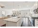 Open concept living area with views to the kitchen, dining area, stainless appliances, and granite countertops at 4645 Dandelion Way, Cumming, GA 30040