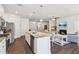 Spacious kitchen and living room combo, complete with granite countertops, stainless steel appliances, and an inviting fireplace at 4645 Dandelion Way, Cumming, GA 30040