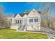 Beautiful white bungalow with a blue door, covered porch, and a lush green lawn at 1337 M L King Jr Nw Dr, Atlanta, GA 30314