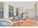 Cozy covered porch with wicker furniture and red-tiled floor, perfect for relaxing at 1337 M L King Jr Nw Dr, Atlanta, GA 30314