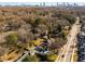 An aerial view of the home and neighborhood shows the nearby Atlanta skyline with mature trees at 1337 M L King Jr Nw Dr, Atlanta, GA 30314