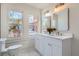 Bright bathroom with a double vanity, white cabinets, and granite countertop and plenty of natural light at 1337 M L King Jr Nw Dr, Atlanta, GA 30314