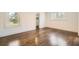 Bedroom featuring hardwood floors, natural light from a large window, and access to a walk-in closet at 1337 M L King Jr Nw Dr, Atlanta, GA 30314