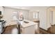 Bright kitchen features an island with a sink and modern fixtures, along with stainless steel appliances and hardwood floors at 1337 M L King Jr Nw Dr, Atlanta, GA 30314