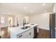 Kitchen with white island, stainless steel dishwasher, hardwood floors, and open layout into other rooms at 1337 M L King Jr Nw Dr, Atlanta, GA 30314