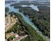 Scenic aerial view showcases the waterfront property with lush greenery and stunning lake views at 2075 Pine Tree Dr, Buford, GA 30518