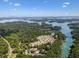 Expansive aerial view of a lakeside townhome community boasting stunning lake and mountain vistas at 2075 Pine Tree Dr, Buford, GA 30518