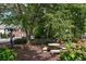 Community park area with picnic tables and benches with beautiful landscaping at 2075 Pine Tree Dr, Buford, GA 30518