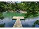 Beautiful lake view from the dock with a platform for relaxing on the water at 2075 Pine Tree Dr, Buford, GA 30518