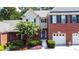 Charming two-story home boasts a brick facade, well-manicured landscaping, and a two-car garage at 2075 Pine Tree Dr, Buford, GA 30518