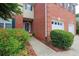 Attractive brick home featuring a well-maintained lawn, colorful flower beds, and an attached two-car garage at 2075 Pine Tree Dr, Buford, GA 30518