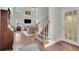 Bright living room with hardwood floors, high ceilings, and staircase at 2075 Pine Tree Dr, Buford, GA 30518
