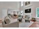 Inviting living room featuring a fireplace, comfortable seating, and an open layout to the kitchen at 2075 Pine Tree Dr, Buford, GA 30518
