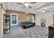 Finished basement space featuring a modern sofa, wood accents, and ample natural light at 2075 Pine Tree Dr, Buford, GA 30518