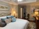 Comfortable main bedroom with soft lighting and decorative pillows at 2075 Pine Tree Dr, Buford, GA 30518