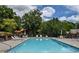 Sparkling community swimming pool with lounge chairs and ample deck space for relaxation at 2075 Pine Tree Dr, Buford, GA 30518