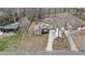 Aerial view showcasing the home's backyard, driveway, and proximity to surrounding trees at 330 Chaffin Ridge Ct, Roswell, GA 30075