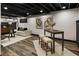 Finished basement featuring stylish flooring and comfortable seating area at 330 Chaffin Ridge Ct, Roswell, GA 30075