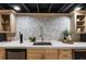 Basement wet bar with white countertop and decorative tile backsplash at 330 Chaffin Ridge Ct, Roswell, GA 30075