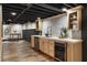 Basement kitchenette featuring light wood cabinets, sink, and a beverage cooler at 330 Chaffin Ridge Ct, Roswell, GA 30075