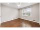 Well-lit bedroom with hardwood floors, ceiling fan, and a window with backyard view at 330 Chaffin Ridge Ct, Roswell, GA 30075