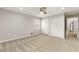 Spacious bedroom with plush carpet, ceiling fan, and a closet for storage at 330 Chaffin Ridge Ct, Roswell, GA 30075