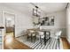 Dining area with wood floors, contemporary art and a modern chandelier at 330 Chaffin Ridge Ct, Roswell, GA 30075