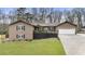 Charming exterior of a well-maintained home with a spacious lawn, garage, and inviting front porch at 330 Chaffin Ridge Ct, Roswell, GA 30075