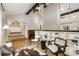 Open-concept living room featuring vaulted ceilings, hardwood floors, and seamlessly connected dining and entry areas at 330 Chaffin Ridge Ct, Roswell, GA 30075
